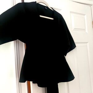 a plunge neck top with a tie.